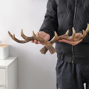 Pair of vintage antler-style wall hooks with realistic brown texture for home decor