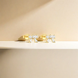 Detailed macro view of S925 sterling silver bow earrings with sparkling white zircon stones