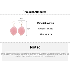 Detail view of pink acrylic oval earrings with marble texture and dimensions 6cm x 3cm