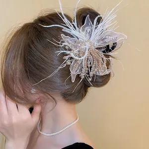 Elegant fabric butterfly hair claw with pearls and feathers for bridal updo hairstyles