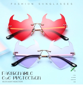 Macro view of red and purple devil heart sunglasses with metal frames and resin lenses