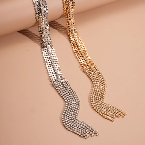 Detailed view of luxury gold and silver tassel chains with sparkling rhinestones