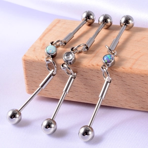 Three-piece industrial barbell set with opal and zircon pendants on purple silk background
