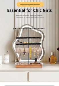 Three-tier jewelry stand with metal hooks, watch roll and wooden base tray detail