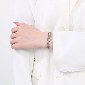 Close-up of double-layer stainless steel Cuban link bracelet on a model's wrist