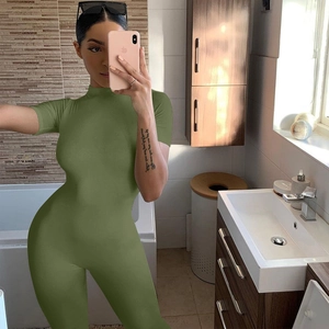 Detail of short sleeve army green slim fit jumpsuit with high neck and front zipper