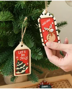 Close-up of wooden Christmas ornaments with reindeer and tree designs on a festive tree