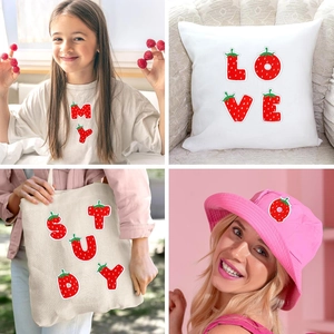 Red strawberry embroidered letter patches applied on white t-shirt and canvas tote bag