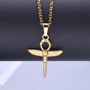 Detailed close-up of golden Egyptian Ankh and scarab pendant with intricate wings