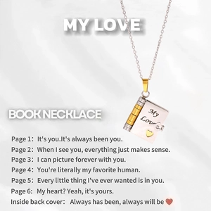 Macro detail of engraved stainless steel book necklace with My Love inscription
