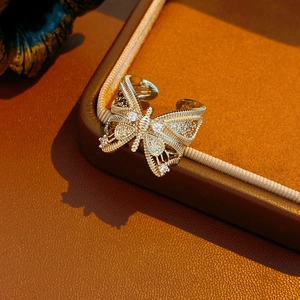 Macro detail of vintage hollow bowknot ring with cubic zirconia on gold plating