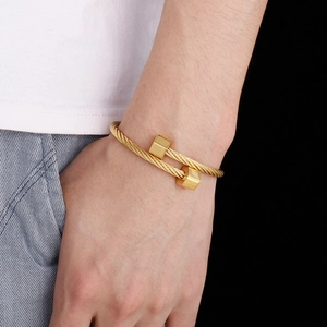 Detailed macro shot of gold hexagonal open bangle featuring twisted wire texture for men