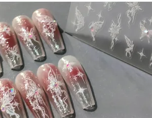 Detailed view of 5D nail stickers featuring white butterflies and shimmering rhinestones