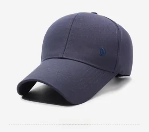 Detail of navy blue twill baseball cap with XIN SHENG embroidery and curved brim