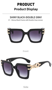 Detail of square oversized black sunglasses with luxury gold chain temples and grey lenses