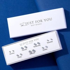 7-day minimalist stud earring set with round-cut crystals in a white gift box