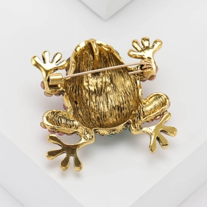 Detailed back view of a luxury gold frog brooch showing the secure safety pin clasp