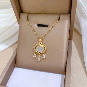 Detail view of a luxury gold cat eye stone lock pendant necklace on white silk cloth
