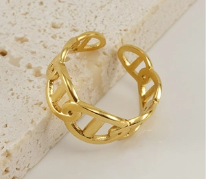 Macro detail of 18k gold plated stainless steel H-link anchor ring with mirror finish