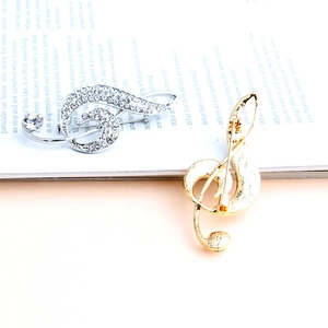 Sparkling treble clef music note brooches with rhinestones in gold and silver finish