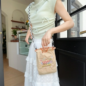 Detailed embroidery on khaki Oxford fabric crossbody bag with braided rope strap