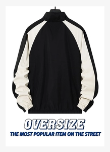 Details zur schwarz-weißen Oversize-Jacke mit Raglanärmeln und elastischen Rippbündchen
