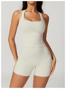 Detail view of cream racerback sports bra and high-waisted shorts in matte stretchy fabric