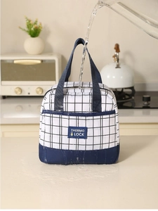 Waterproof detail of thermal lunch bag featuring water droplets on checkered fabric