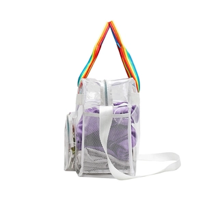 Detail view of transparent PVC tote bag with rainbow handles and side mesh pocket
