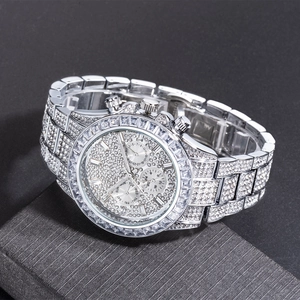 Macro detail of silver iced-out watch showing multifunctional subdials and full crystal setting