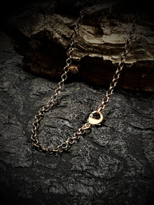 Vintage bronze metal chain necklace 60cm with lobster clasp on a dark textured wood background