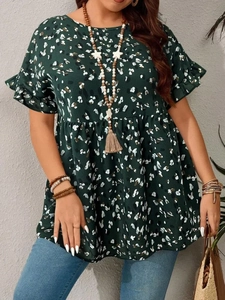 Detail of dark green floral puff sleeve blouse featuring an oversized babydoll fit