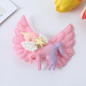 Detail of pink glitter unicorn hair clip with wings and gold star for girls