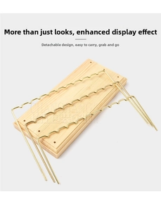 Close-up of detachable wave-shaped gold metal jewelry stand with a natural wooden base