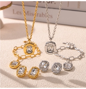 Detailed view of luxury gold and silver jewelry set with emerald cut rectangle crystals