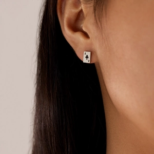 Close-up of Ace of Clubs poker card earring in silver stainless steel on model's ear