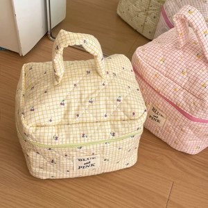 Quilted cotton makeup bags featuring cherry patterns, plaid designs, and top handles