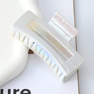 Top view of a rectangular laser pearlescent hair claw clip in iridescent white finish