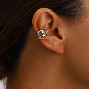 Close-up of gold and silver thick circular ear cuffs on ear for non-pierced ears