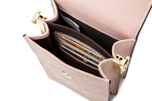 Detail view of pink textured leather phone bag with card slots and interior lining