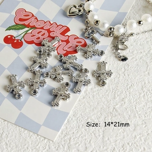 Macro shot of 14x21mm silver cross charm for DIY jewelry and Y2K beaded accessories