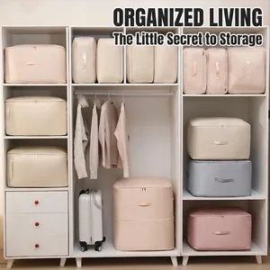Satin compression storage bags for clothes and quilts organized in a white wardrobe