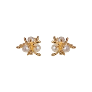 Elegant gold flower stud earrings with three round white pearls on a clean white background