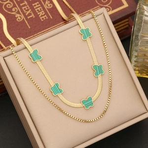 Double-layered gold necklace with flat snake chain and green clover malachite pendants