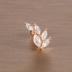 Macro shot of rose gold leaf ear stud with marquise-shaped zircons and screw back