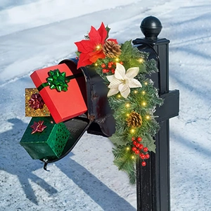 Lighted Christmas mailbox swag with red flowers, pinecones, berries and LED lights