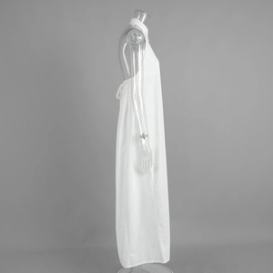 Detail view of white halter neck maxi dress with waist tie and A-line cotton silhouette