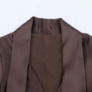 Detail shot of the silky brown satin neckline showing premium fabric texture and drape