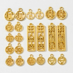 Detailed flat lay of golden Chinese lucky charms for DIY jewelry and keychain making
