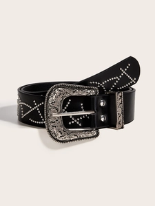 Detail of vintage carved silver buckle and metal rivets on black punk western belt